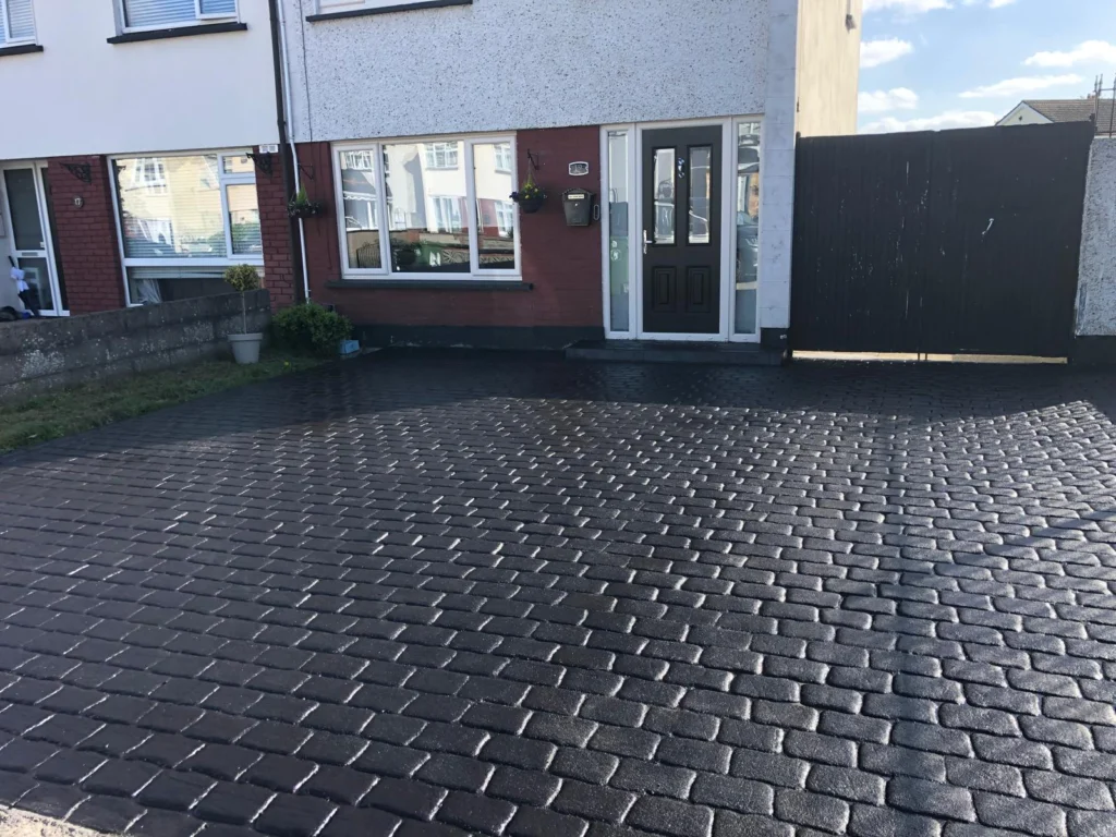 Stamped concrete driveway featuring a cobblestone pattern by Concrete Driveways Dublin